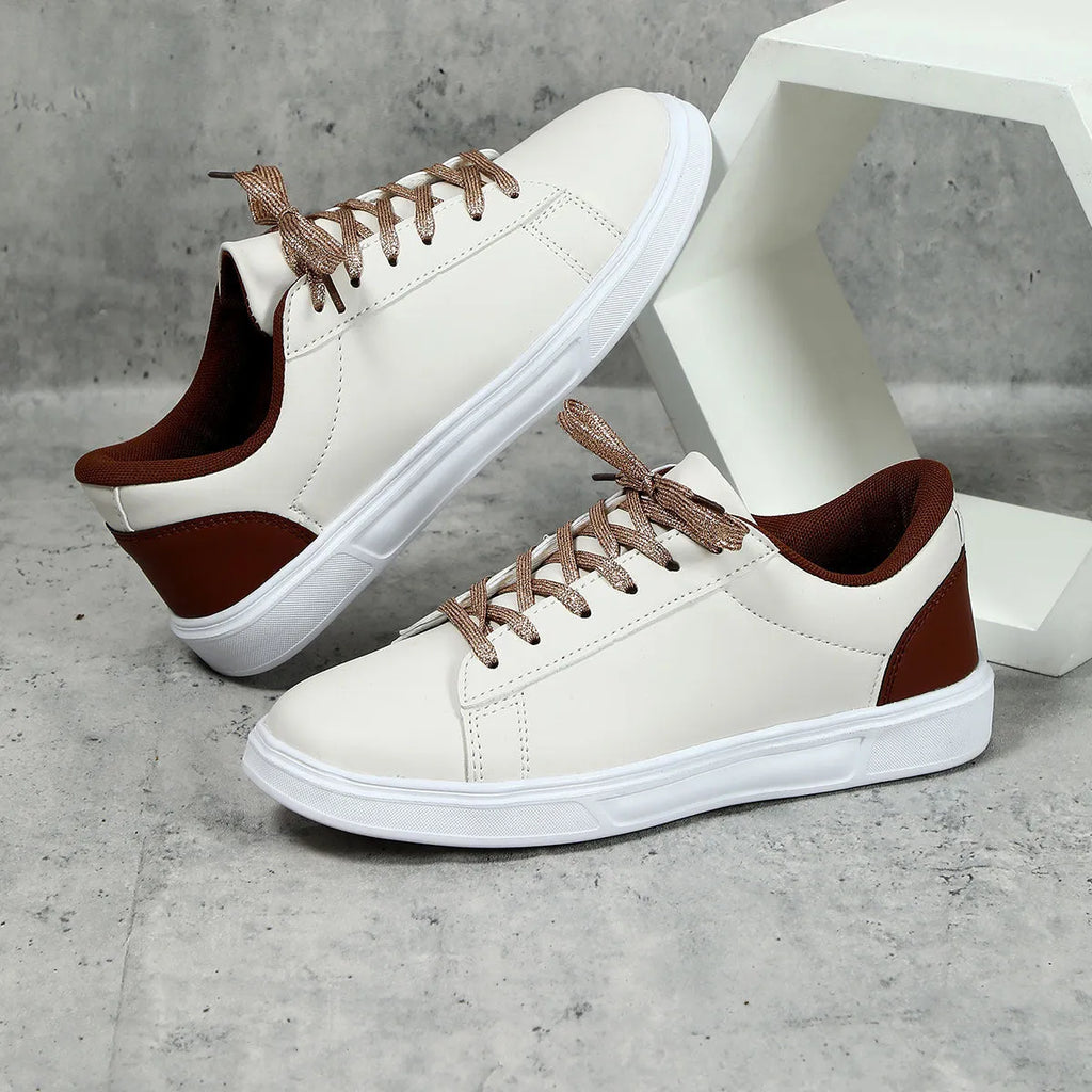 Beige brown casual platform sneakers with a cross strap and round toe on a rubber sole.