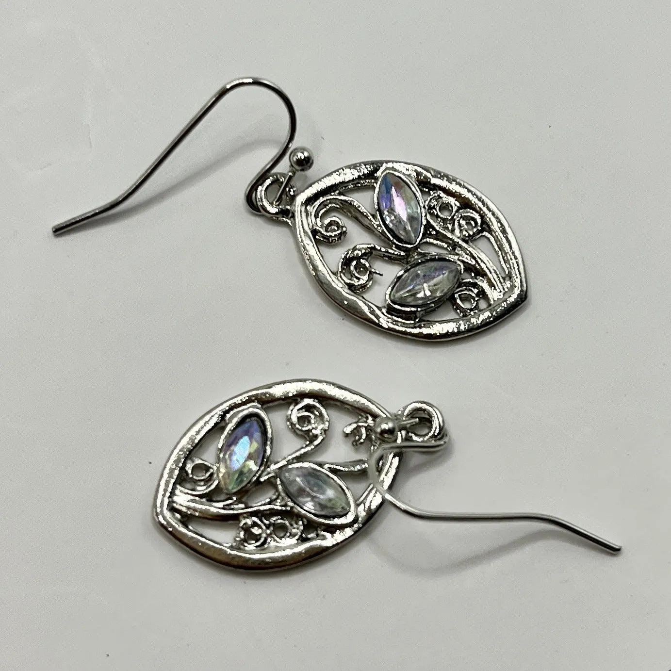 Silver alloy earrings with leaf shape containing colourful embedded moonstone