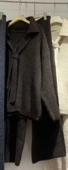 Beige acrylic imitation cashmere knitted top and trouser two-piece set on a hanger.