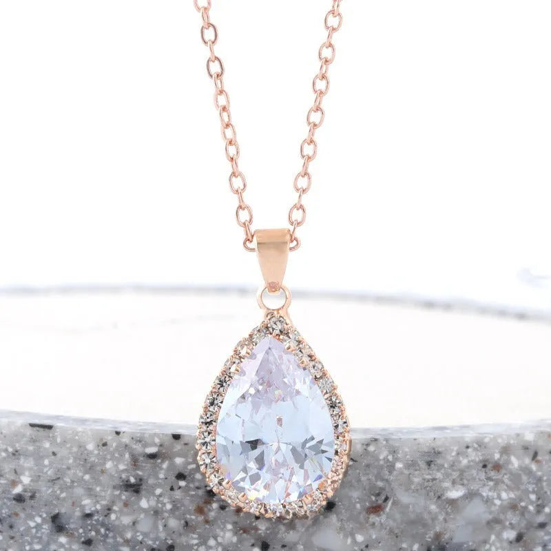 Rose gold electroplated necklace with water drop shaped geometric pendant and rhinestone detailing