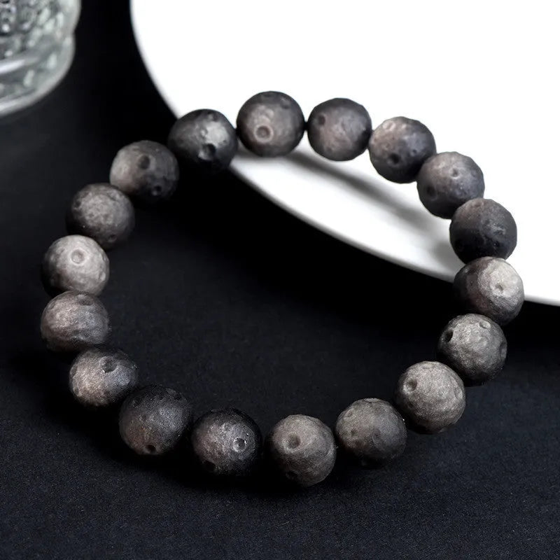 Obsidian crater ball bracelet with grinding texture in silver or golden meteorite colours