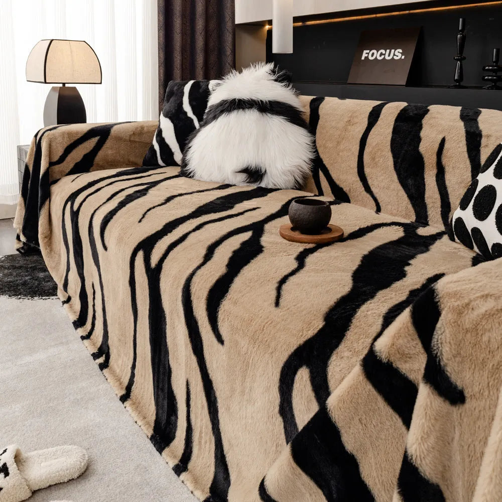 Zebra pattern flannel sofa cover with non-slip backing shown in a caramel colour.