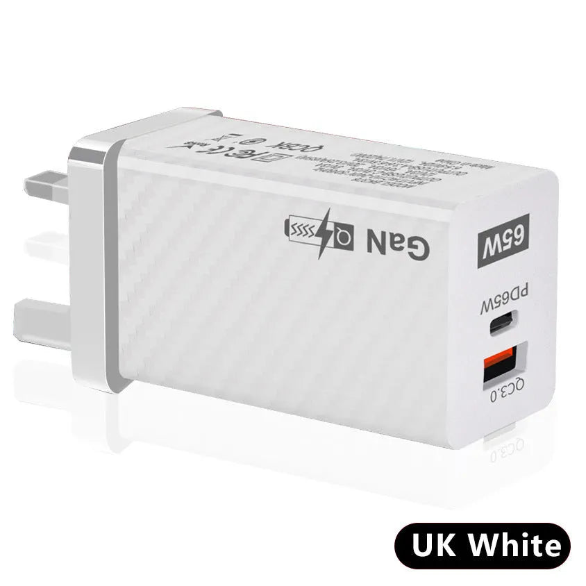 White and black 65W GaN laptop charger with USB-C port, shown next to EU and US plug options for scale.