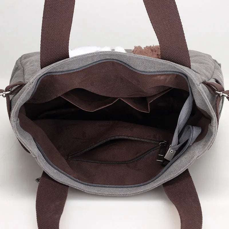 KVKY canvas handbag with plush cat applique in beige colour on a woman's shoulder