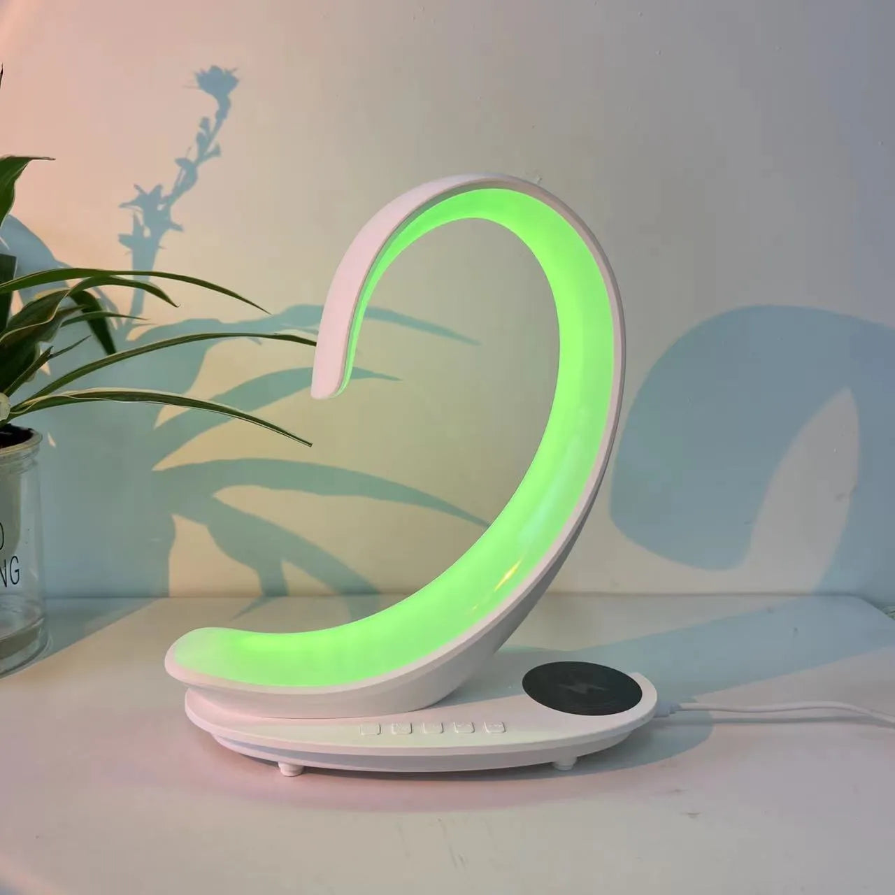 White swan shaped desktop lamp with wireless charging pad, Bluetooth speaker, and colourful LED lighting
