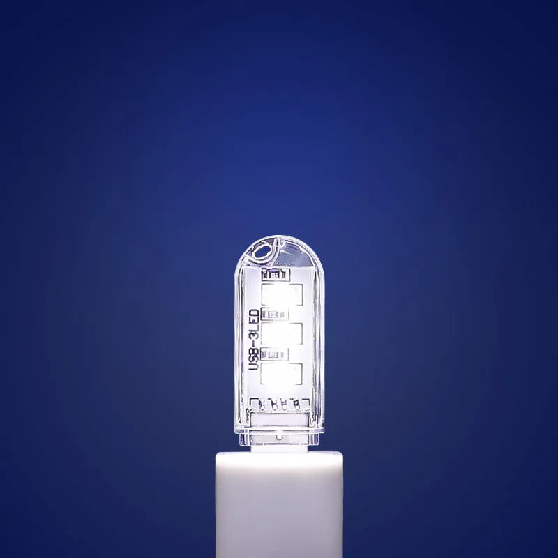 Compact white USB-powered LED baby night light with choice of warm or white light colour.
