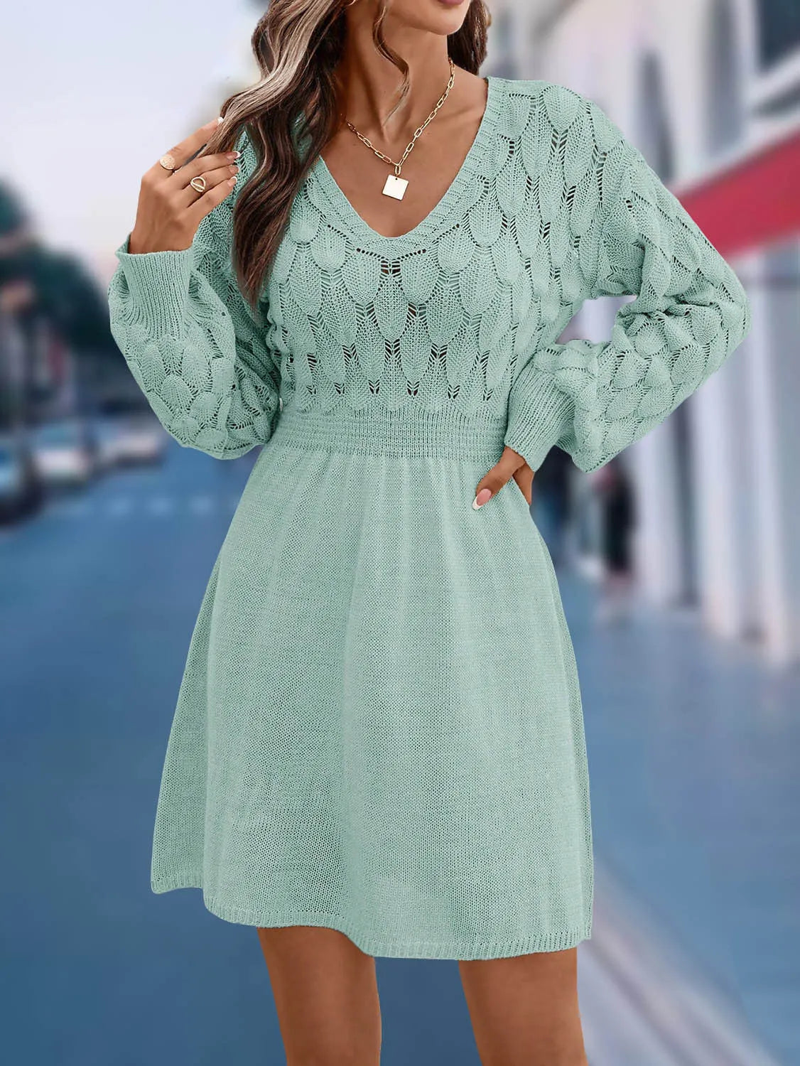 Woman wearing an apricot coloured acrylic V-neck ethnic dress with 3D patterns and a high waist.