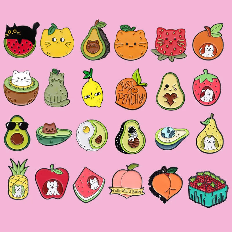 Colourful cartoon fruit shaped into a letter on a metal brooch with pin clasp.