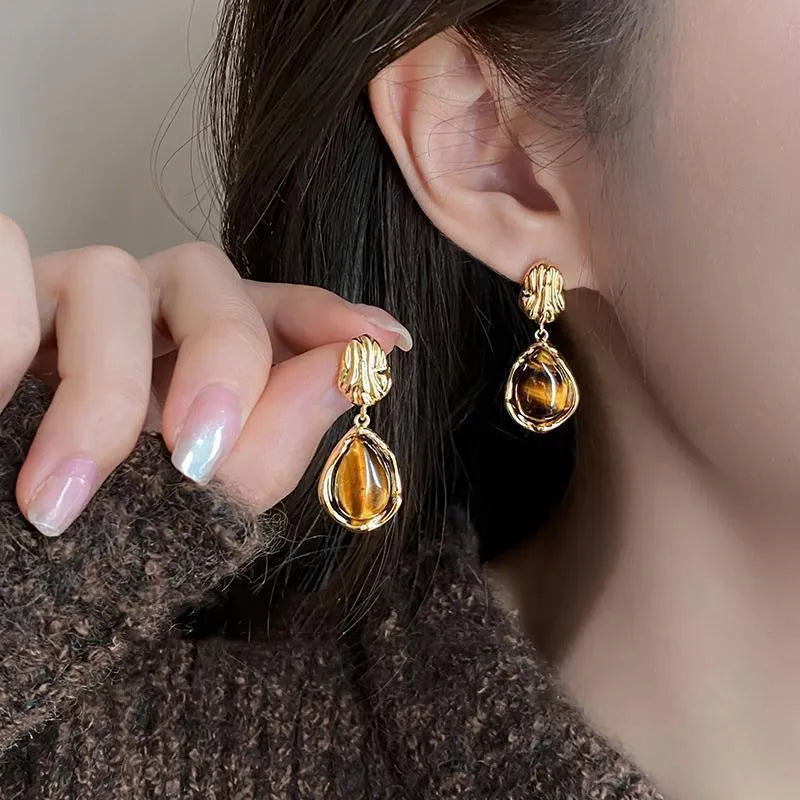 Three pairs of handmade geometric holiday earrings with tassel details in electroplated alloy