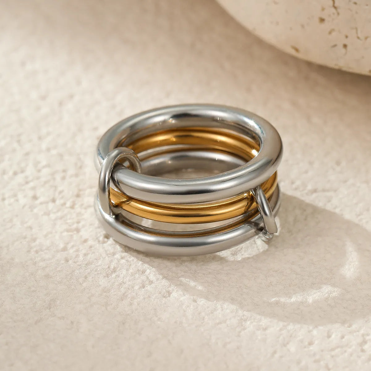Stackable stainless steel rings with 18K gold plating in colour matching bands, exaggerated modern design