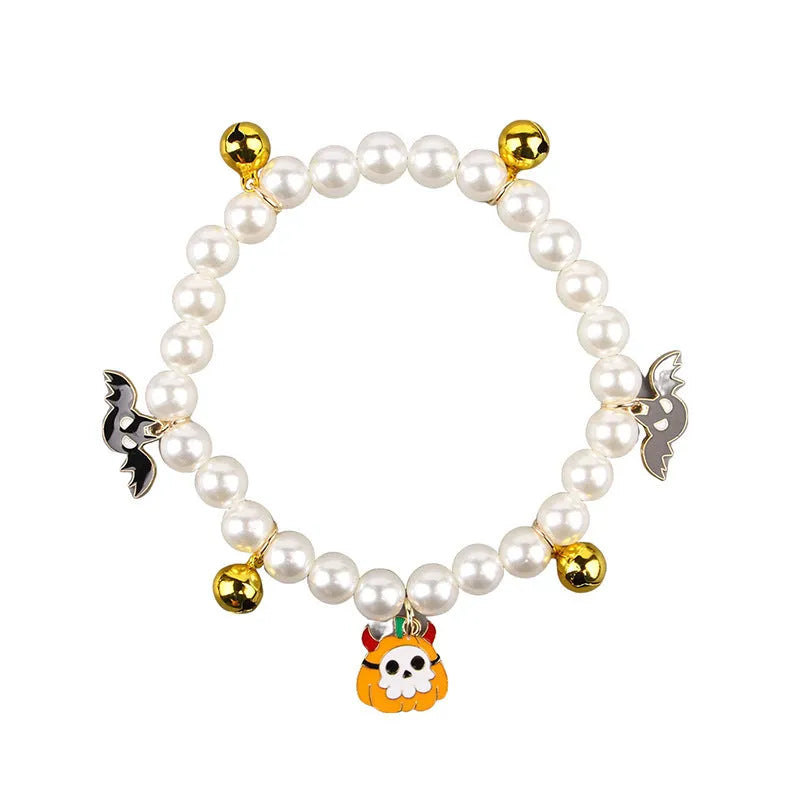 Halloween cat collar with simulated pearls and pumpkin designs including purple ghost, skull, and smiling pumpkin patterns