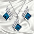 Women's necklace and earring set with glass pendant on cross chain, alloy material with electroplated finish