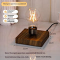 Iron art suspension bulb night lamp on a black wood grain desktop base.