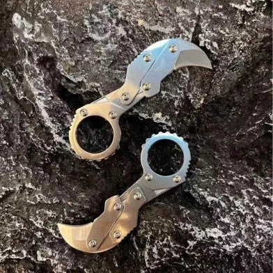 Small stainless steel 420J2 folding knife with 2.6cm blade on table