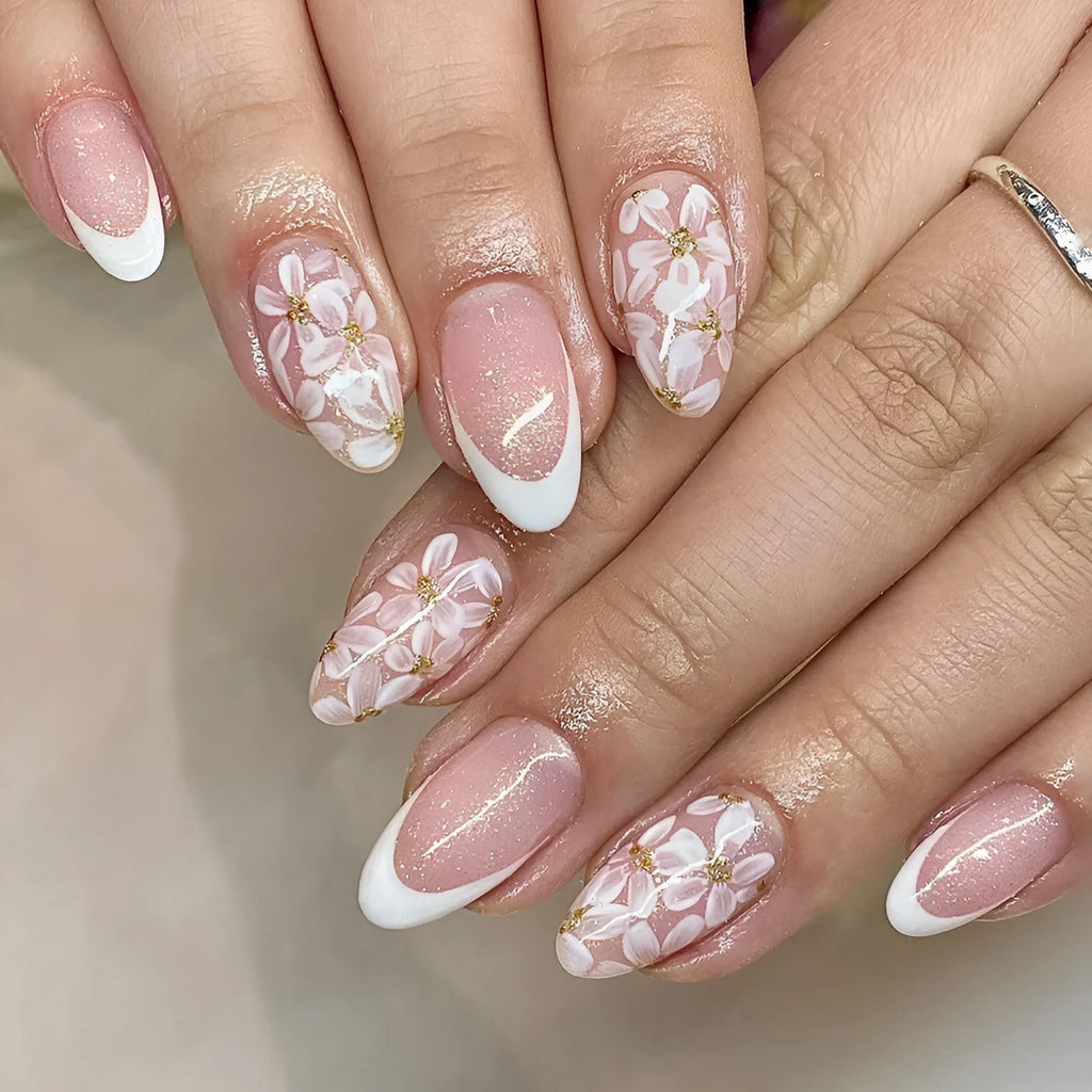 Glossy almond shaped press-on nails with French style white tips and glitter powder floral design in C625 pattern