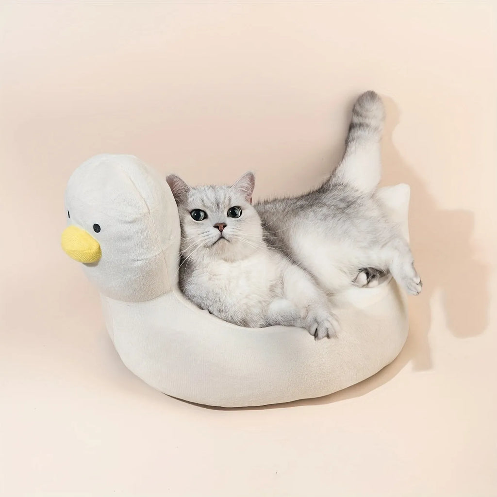 Blue duck-shaped fluffy pet bed sofa for small dogs and cats on a wooden floor.