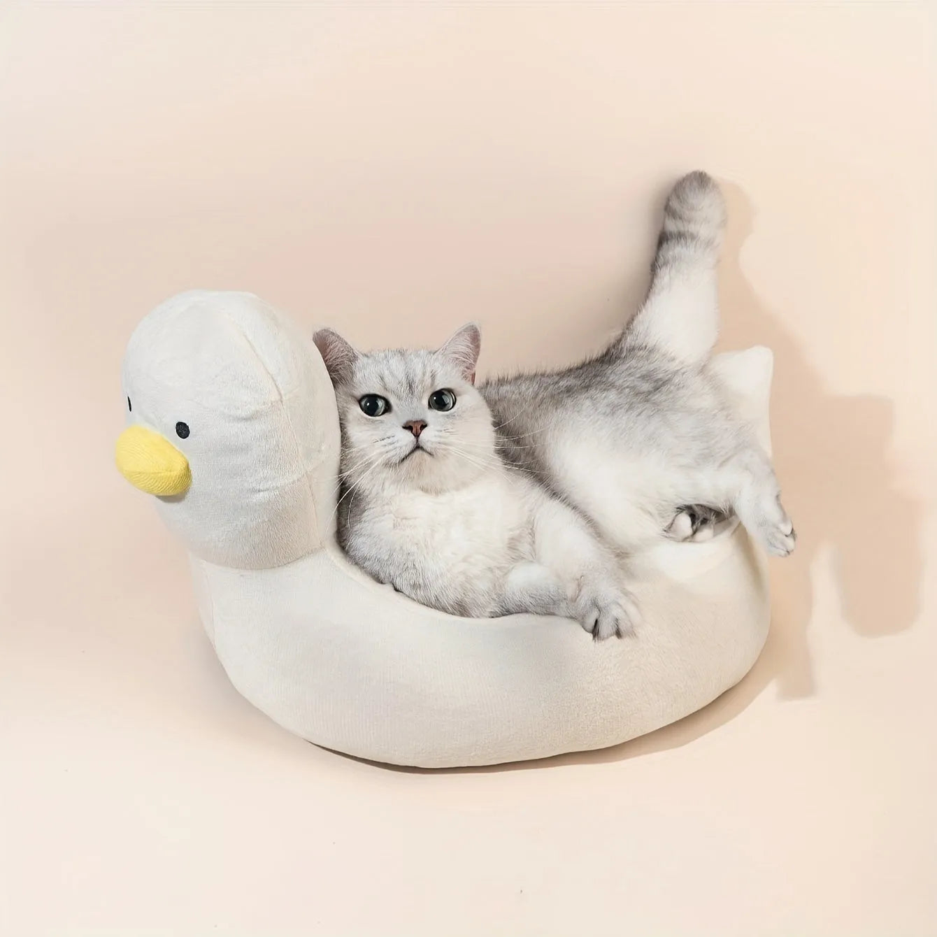 Blue duck-shaped fluffy pet bed sofa for small dogs and cats on a wooden floor.