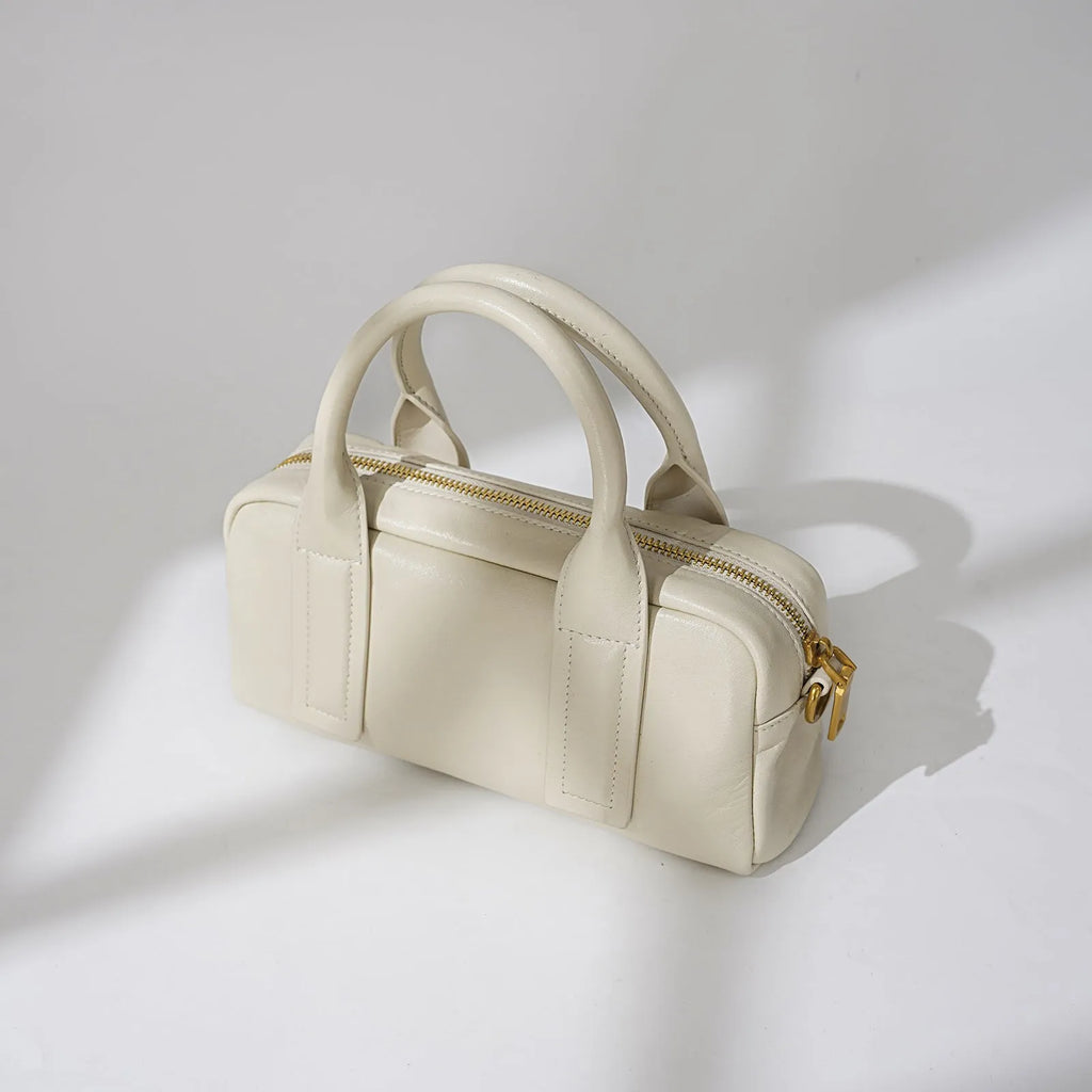 Genuine first layer cowhide crossbody bag in horizontal square shape with external sandwich pocket, available in black, brown, or milkshake white
