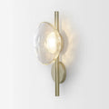 Bedside hotel glass art wall lamp with transparent lampshade and iron body on a wall