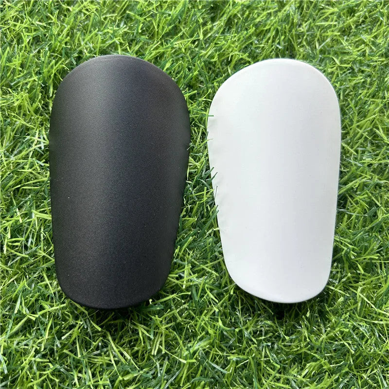 Extra small plastic football shin guards measuring 8cm by 5cm with elastic straps