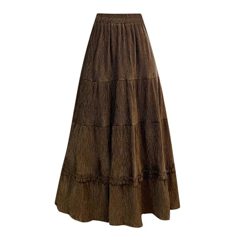 Beige corduroy A-line midi skirt with an elastic waistband laid flat.