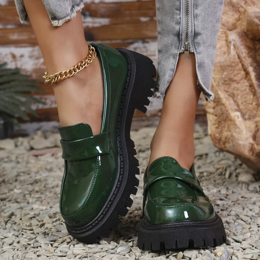 Plus size black chunky heel loafers with a thick rubber sole and slip-on design.