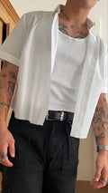 White men's cropped short sleeve polyester shirt on a hanger