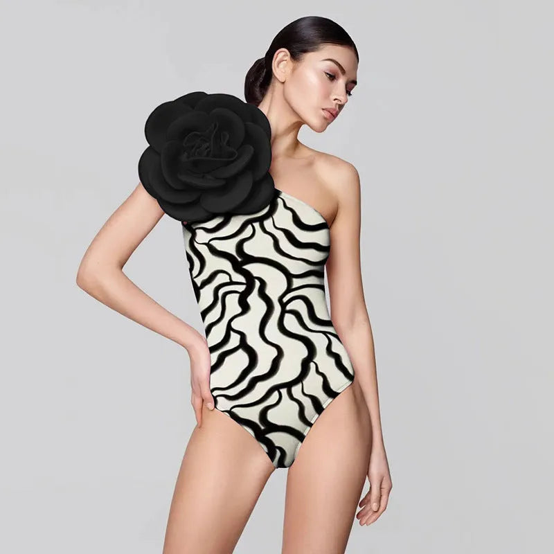 Women's solid colour one-piece swimsuit with three-dimensional flower design.