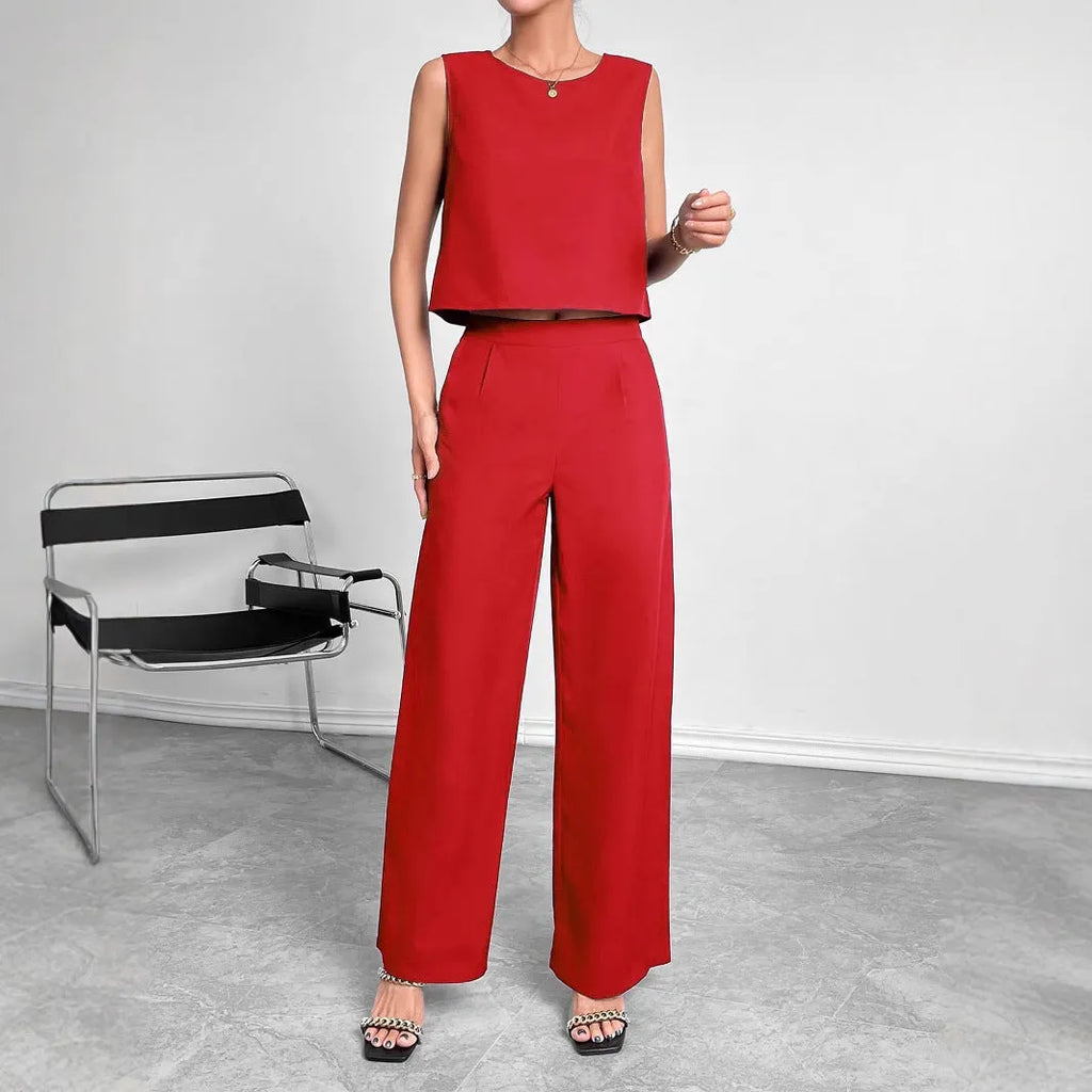 Women's red polyester two-piece set featuring a sleeveless top and wide-leg trousers on a hanger.