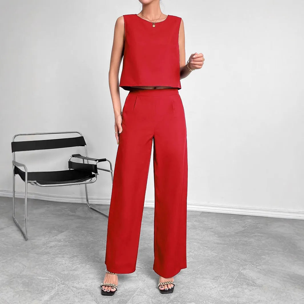 Women's red polyester two-piece set featuring a sleeveless top and wide-leg trousers on a hanger.