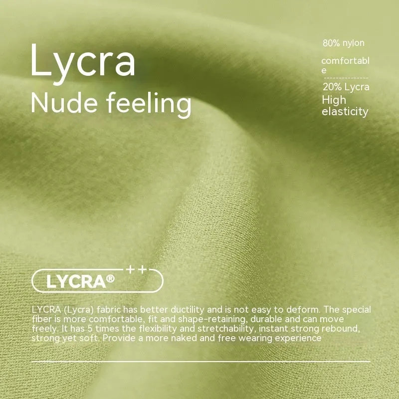 Woman wearing high-waisted leaf green Lycra yoga shorts with a four-point anti-exposure design.