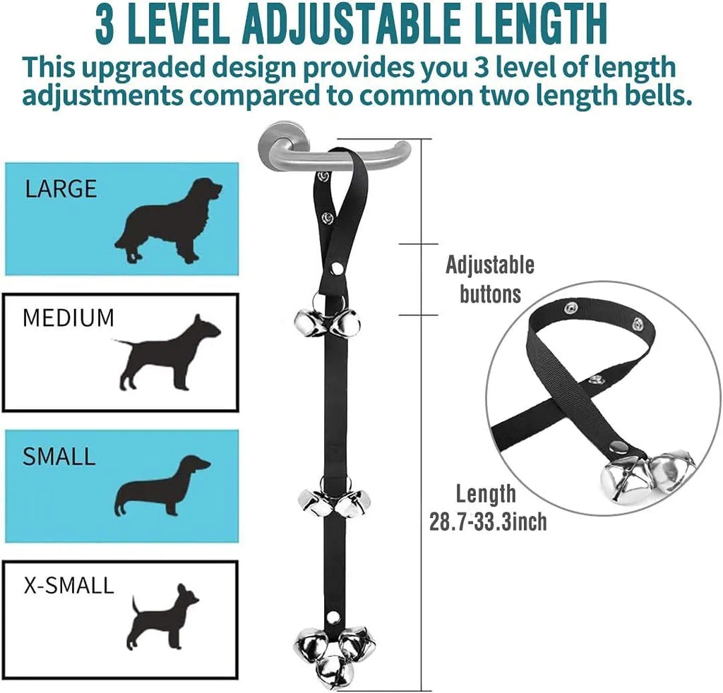 Silver metal dog training bells on an adjustable black nylon leash hanging from a door handle.