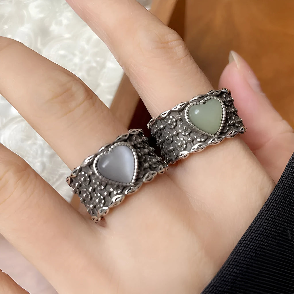 Retro wide-faced heart-shaped ring with adjustable opening in silver finish.