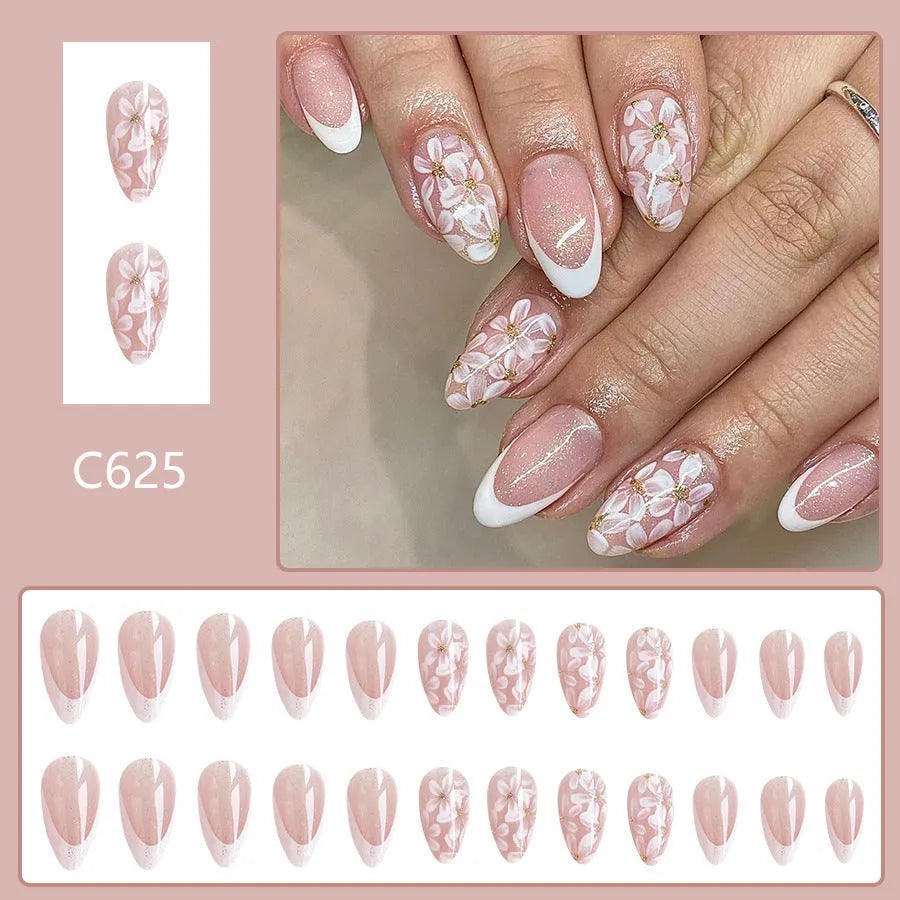 Glossy almond shaped press-on nails with French style white tips and glitter powder floral design in C625 pattern