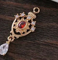 Small hollow water drop pendant with zircon accents in one of five colours.
