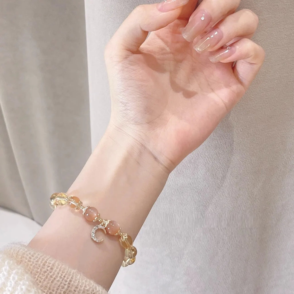 Chinese style women's crystal bracelet with a citrine moonstone and 14K gold electroplating.