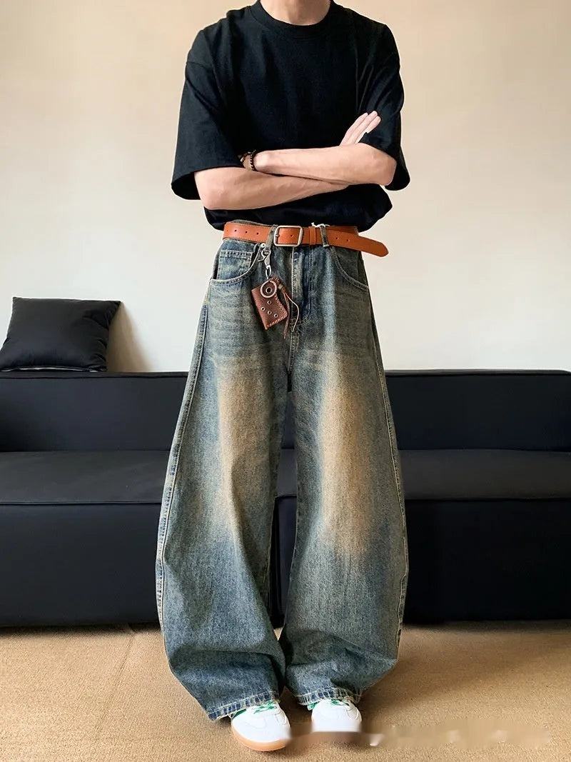 Retro blue distressed machete denim jeans for men with a wide-leg slim cut.