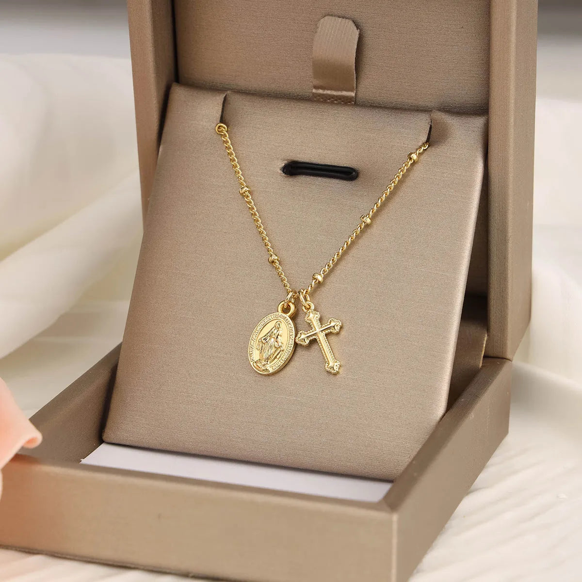 Gold Virgin Mary cross necklace with geometric pendant design for women