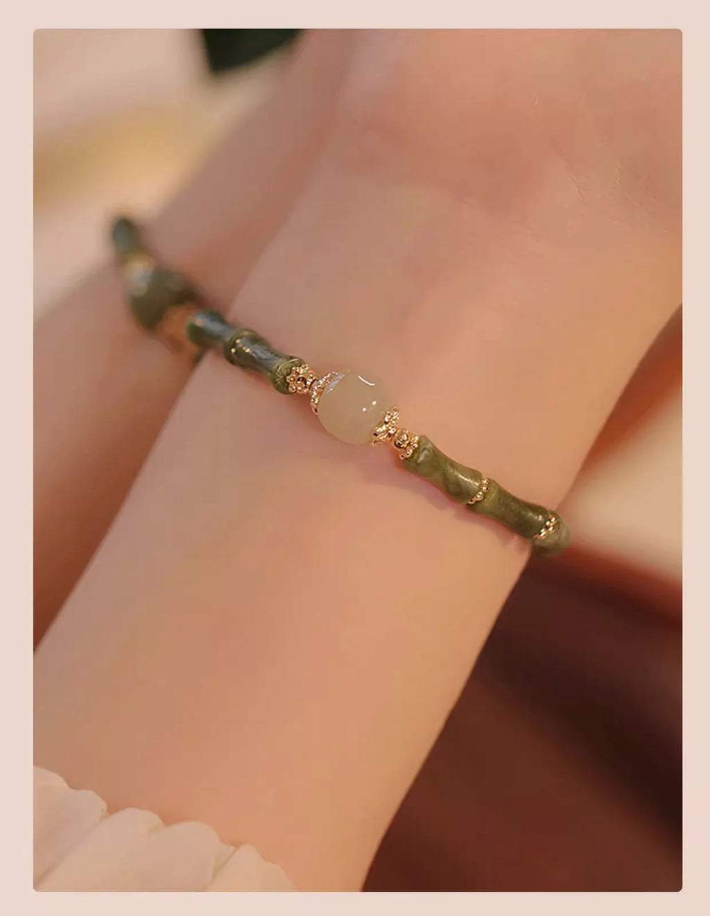 Women's simple geometric Hetian jade bracelet in dark green and light colour on a white background.