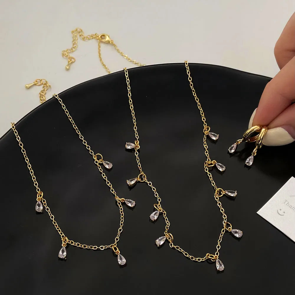 Zircon jewellery set with geometric necklace, matching earrings, and anklet featuring meteor shower design