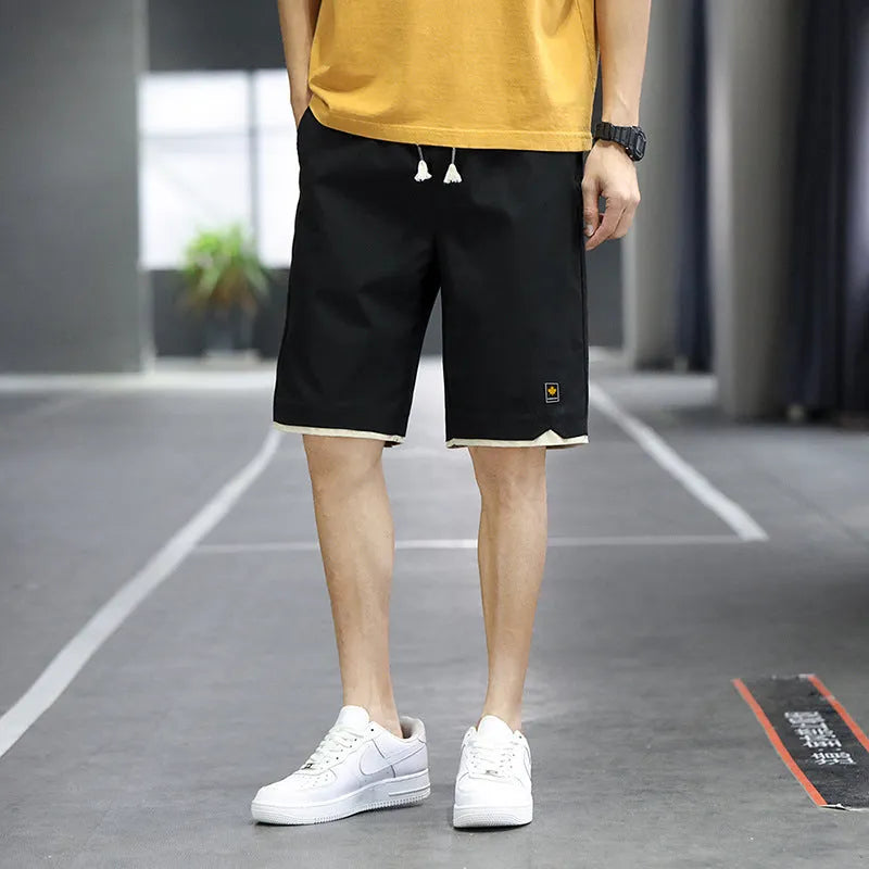 Men's loose-fitting Korean-style casual shorts in khaki, shown on a model.