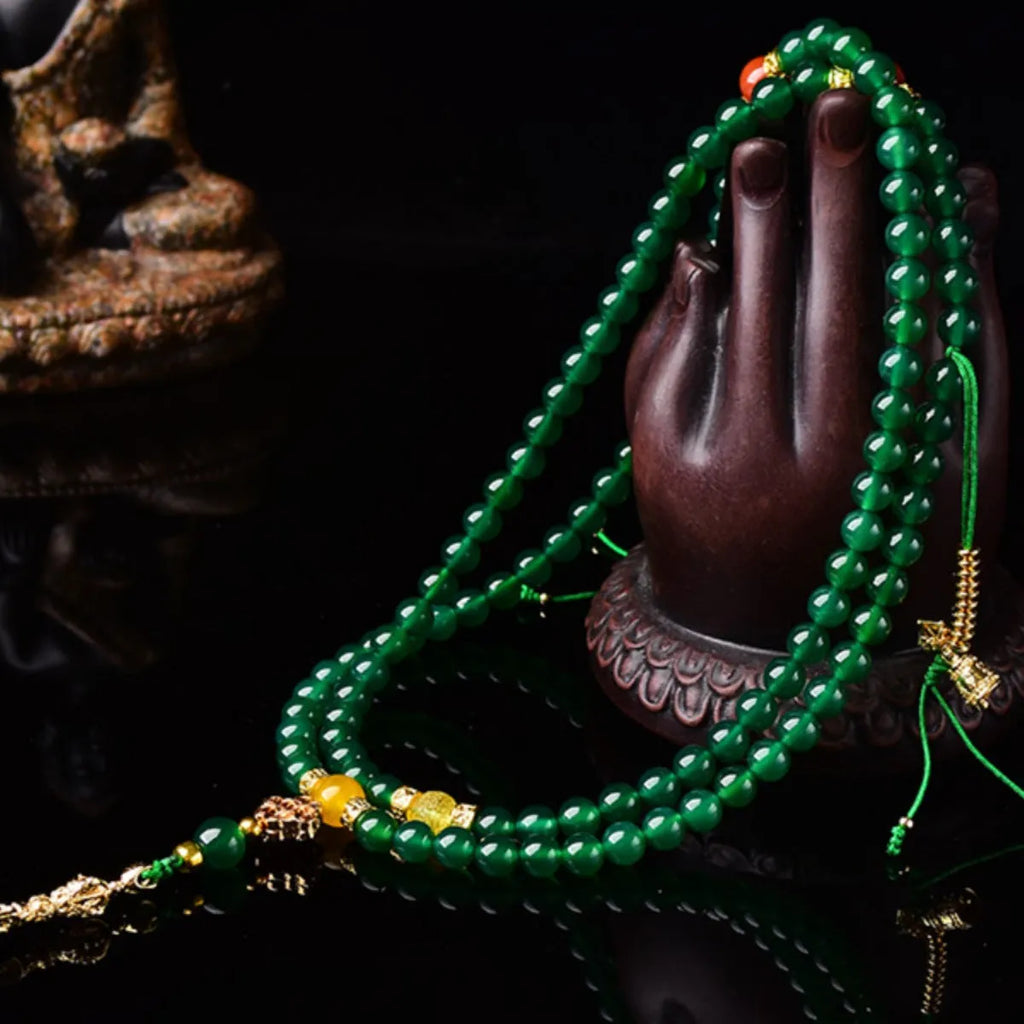 Close-up of a multi-circle green agate bracelet for men and women on a wrist.