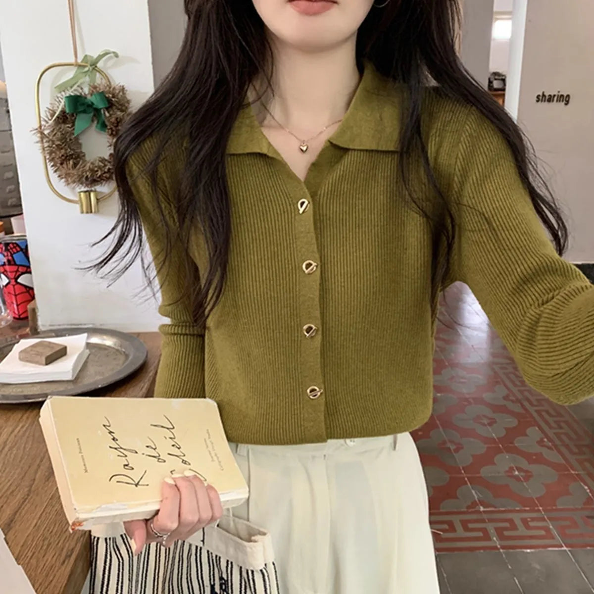 Beige loose fit long-sleeved viscose knitted cardigan for women shown as a layering piece.