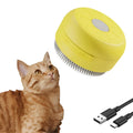Green and yellow rechargeable silicone steam brush for grooming cats and dogs.