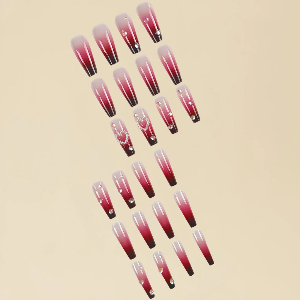 Wine red gradient false nail tips with plaid pattern and pearl heart accents in a long ballet shape.