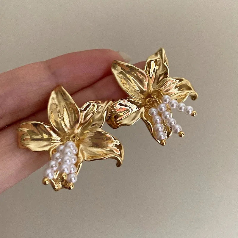 Gold H1795 colour exaggerated pearl flower earrings with metal construction and floral design elements