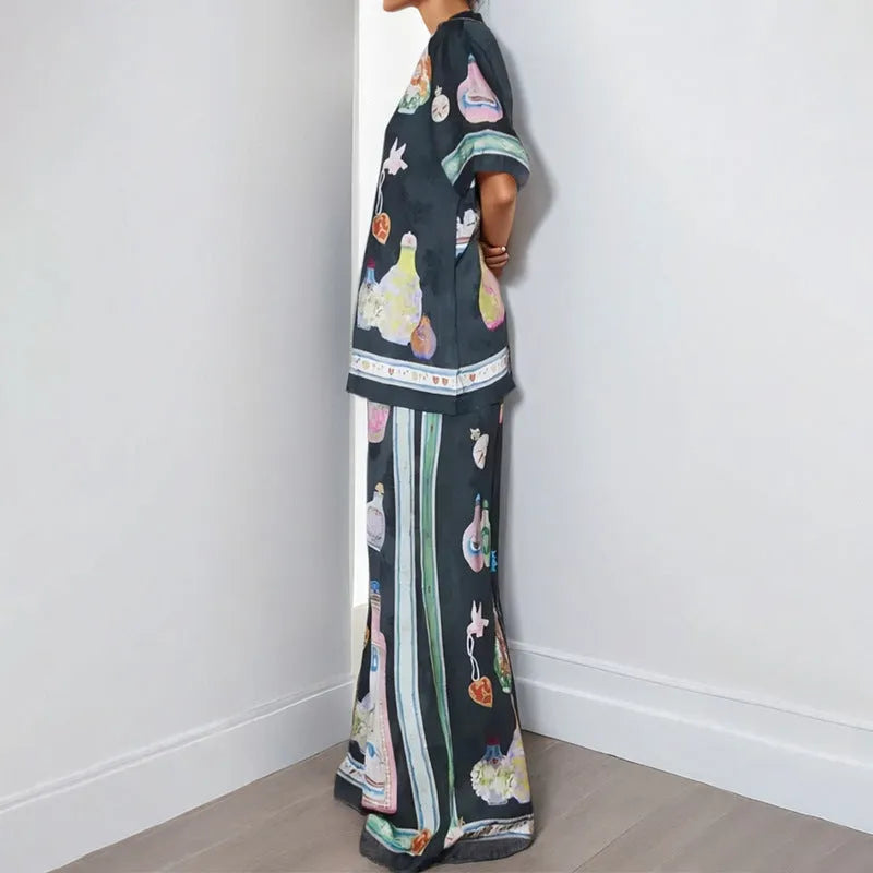 Black women's sleeve cardigan and trousers matching set with cartoon animation pattern.
