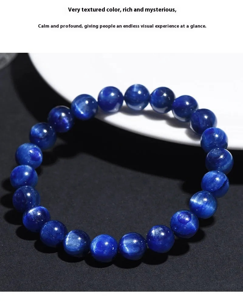 Polished blue crystal ball bracelet with geometric beads and Ruyi design on a white background.