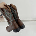 Brown women's embroidered mid-calf Martin boots with leather lining and a square heel.