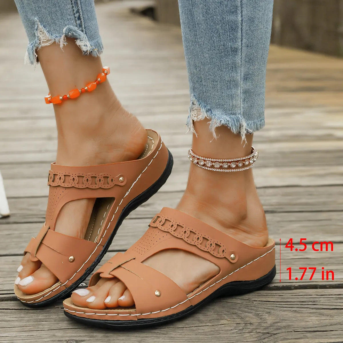 Blue casual slippers with a fish mouth toe holder and slope heel on a wooden floor.